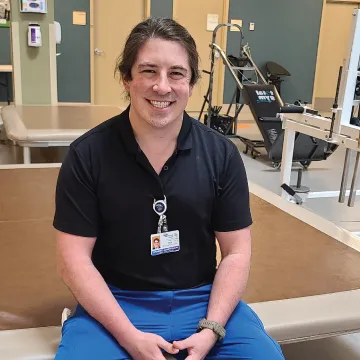 Headshot of Eric Ross wearing scrubs.